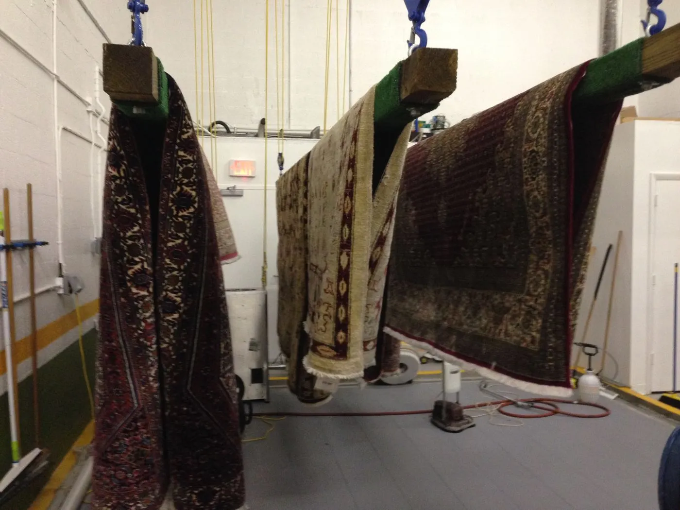 Washed rugs drying on the plant&rsquo;s racks in controlled air