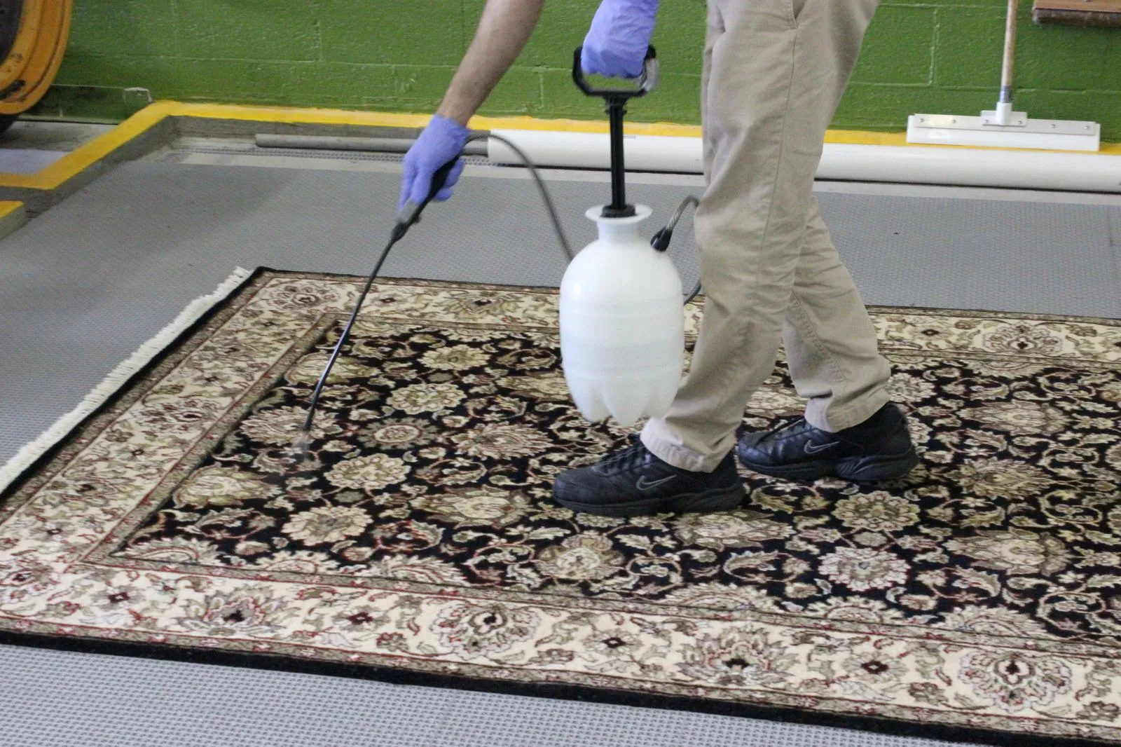 Rug pre-treated flat on the wash floor before its full wet wash